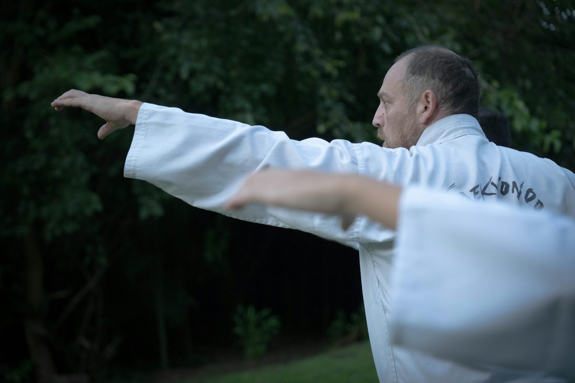 Close-up of martial artists practicing Taekwondo outdoors in Buenos Aires.